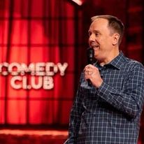 Photo of Brian Bates, comedian, performing at a comedy club